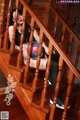 A woman sitting on the stairs holding a basketball.