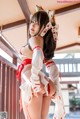 A woman in a red and white outfit posing for a picture.