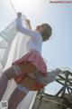 A woman in a skirt and stockings is hanging on a clothes line.