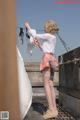 A woman in a skirt and stockings is hanging on a clothes line.